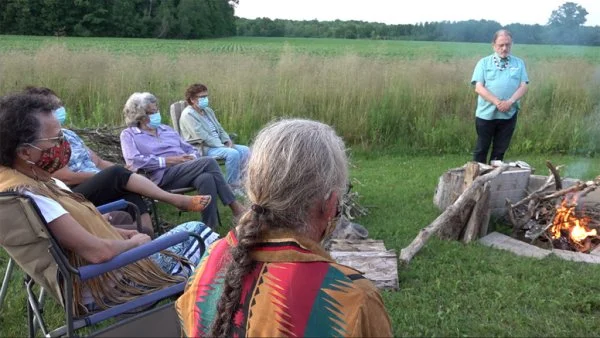 Members of Sacred Circle, led by National Indigenous Archbishop Mark MacDonald, gather at the lighting of the Sacred Fire during the tenth meeting of the national Indigenous Anglican gathering at Six Nations of the Grand River, Ontario
