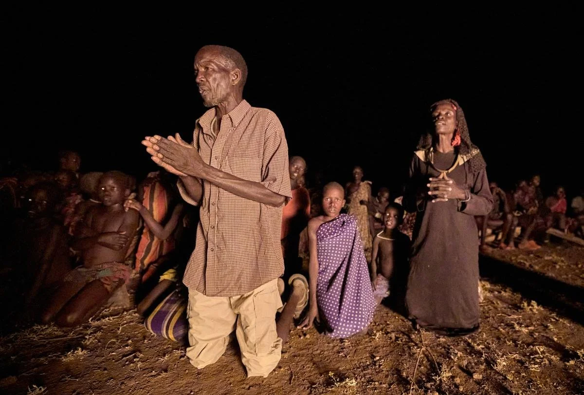 People pray during a nighttime vigil for peace in Nakubuse, a small village near Kuron in South Sudan's Eastern Equatoria State. The region has been plagued by cattle raiding and child abduction in recent years. The Catholic Church-sponsored Holy Trinity Peace Village, centered in Kuron, has worked for years to foster reconciliation and peace between the region's pastoralist communities
