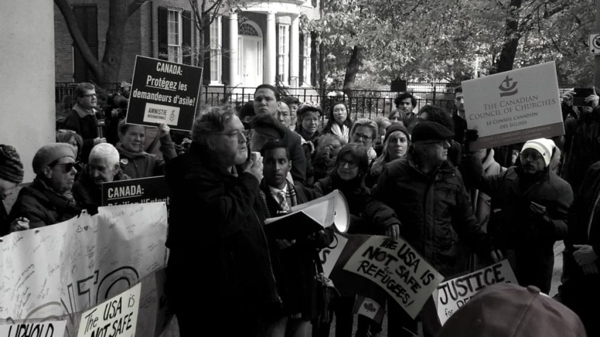 Pastor Peter Noteboom, General Secretary of the Canadian Council of Churches, speaks to a rally about the Canada-US 'Safe Third Country Agreement' (STCA) which has been challenged in court by the CCC together with Amnesty International and the Canadian Council of Refugees