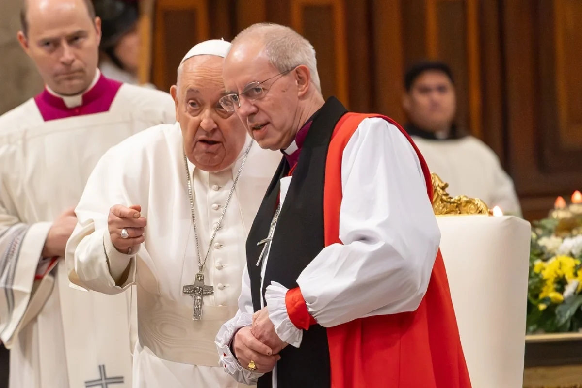 Pope Francis points something out to Anglican Archbishop Justin Welby of Canterbury after an evening prayer service concluding the Week of Prayer for Christian Unity at Rome's Basilica of St Paul Outside the Walls