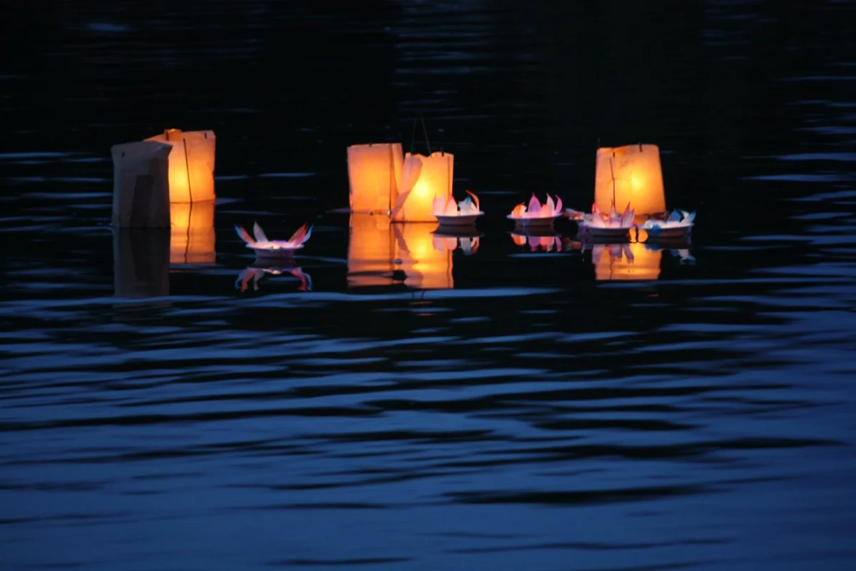 Candles for peace floating on the river Thames near Oxford, England