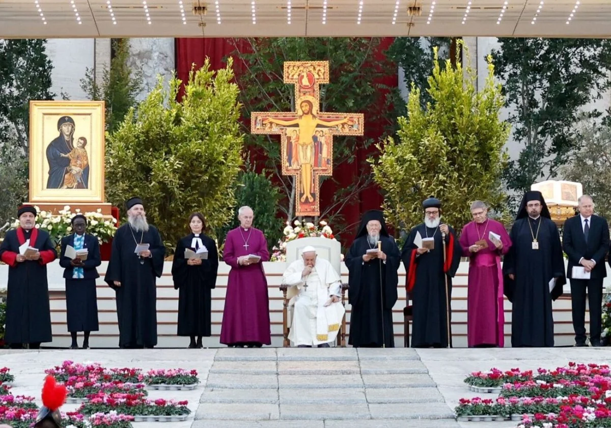 Pope Francis, Orthodox Ecumenical Patriarch Bartholomew of Constantinople, Anglican Archbishop Justin Welby of Canterbury, Rev. Anne Burghardt, general secretary of the Lutheran World Federation, and other Christian leaders stand in front of the San Damiano cross, in front of which St. Francis of Assisi said he heard Jesus tell him to 'rebuild my church.' They were gathered for an ecumenical prayer service titled ‘Together: Gathering of the People of God.’ The prayer service occurred on the eve of the 1st Session of the XVI Ordinary General Assembly of the Synod of Bishops