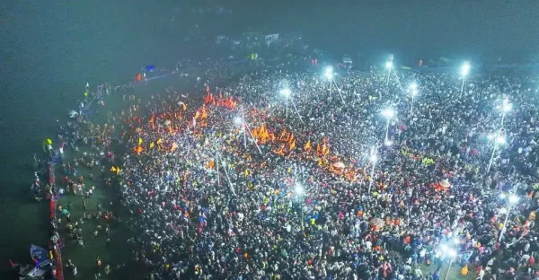 This aerial handout photograph taken and released by India's Uttar Pradesh State Information Department shows Hindu pilgrims taking a holy dip in the sacred waters of the confluence of the Ganges, Yamuna, and mythical Saraswati rivers, during the Maha Kumbh Mela festival in Prayagraj