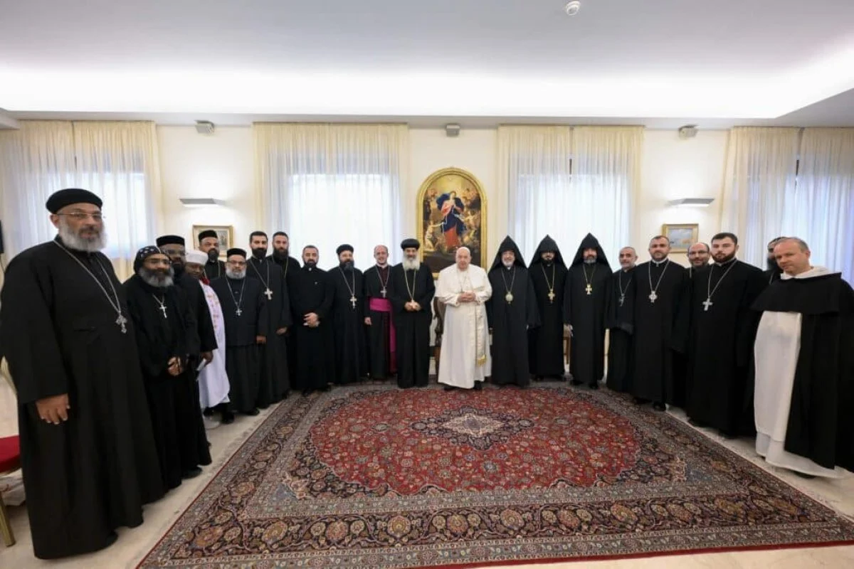 Pope Francis poses for a photo with young priests and monks and other representatives from Oriental Orthodox Churches during a meeting at the Vatican