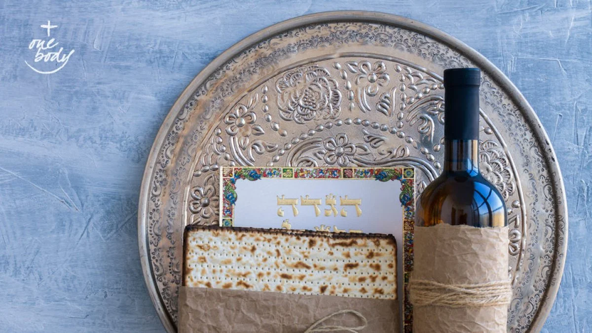 Some of the traditional elements of a Passover Seder: a silver Seder plate, a bottle of wine, a Haggadah or service book, and a package of Matzah or unleavened bread