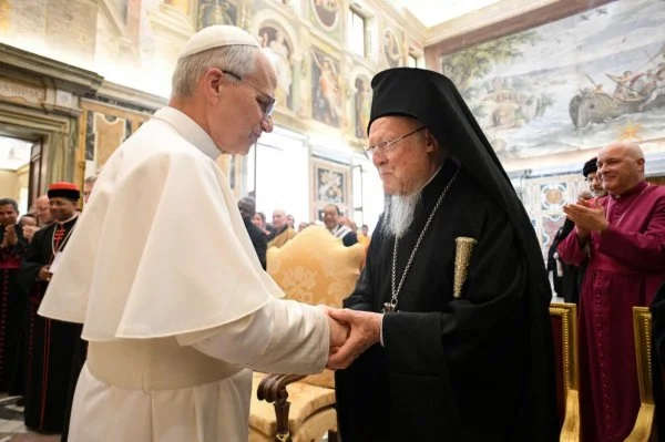 Pope Leo XIV greets Patriarch Bartholome of Constantinople during an audience with ecumenical guests on the day after the inaugural Mass of of his papacy