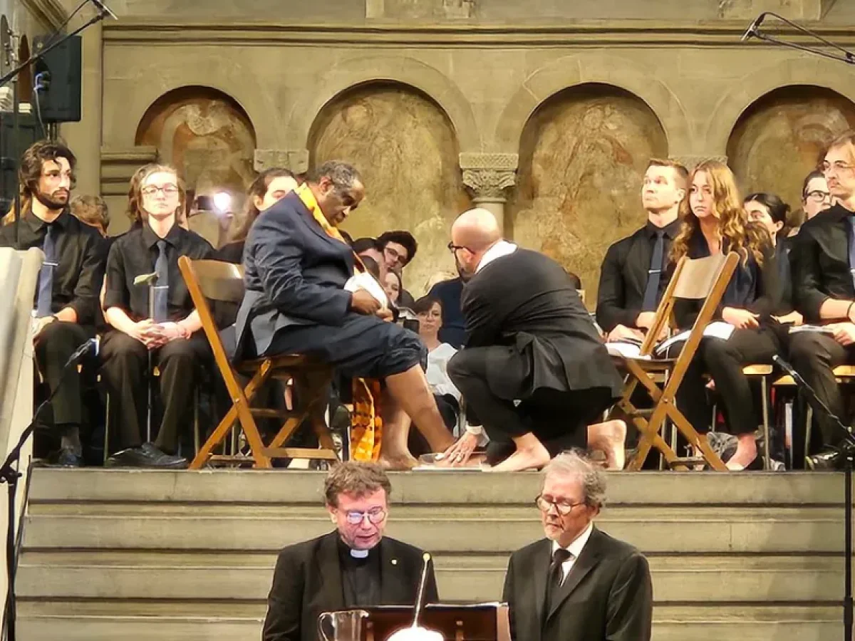 Reformed and Mennonite leaders Setri Nyomi and César Garcia wash one another’s feet in act of reconciliation, while Rev. Dr. Hanns Lessing and Dr. John D. Roth read from 'Restoring Our Family to Wholeness'