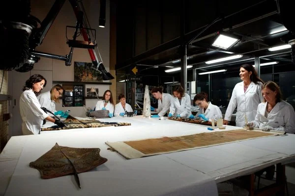 Expert restorers work in the conservation laboratory for ethnological materials at the Vatican Museums in this file photo. Many of the 100,000 artifacts sent to the Vatican via missionaries over the centuries are made of delicate materials such as ostrich plumes, leather and glass beads