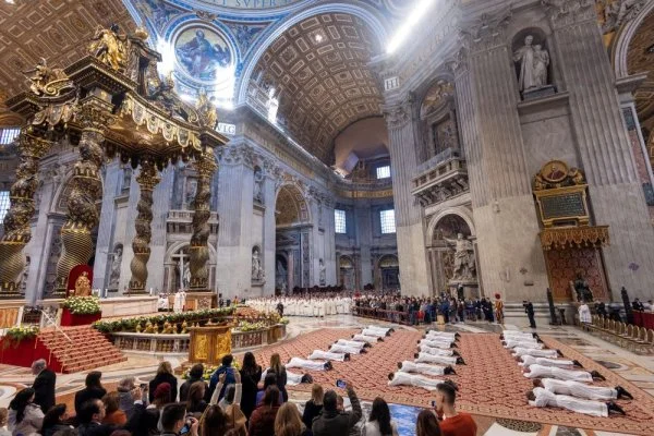 Deacons lie prostrate during ordination Mass in St. Peter's Basilica during the Jubilee of Deacons at the Vatican