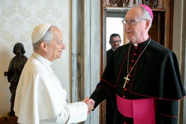 Pope Leo XIV greets Canadian Archbishop Richard Smith of Vancouver, a member of the Canadian Catholic Indigenous Council, in the library of the Apostolic Palace. The pope gave the Canadian bishops 62 artifacts that will be returned to Indigenous communities in Canada