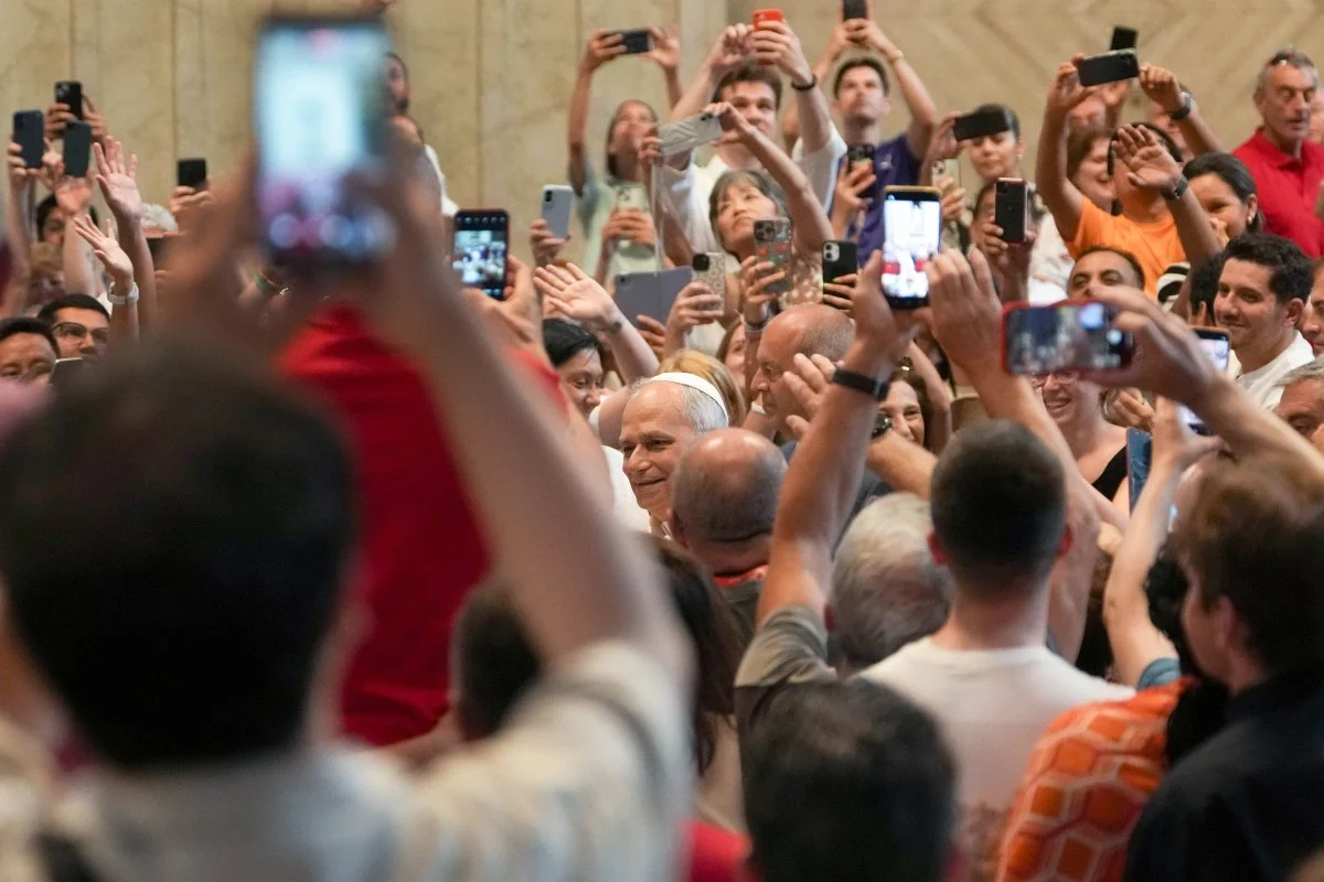 In this file photo, Pope Leo XIV greets people as they hold up cellphones to take photos and videos as he enters St. Peter’s Basilica for an audience with pilgrims in Rome for the Holy Year 2025