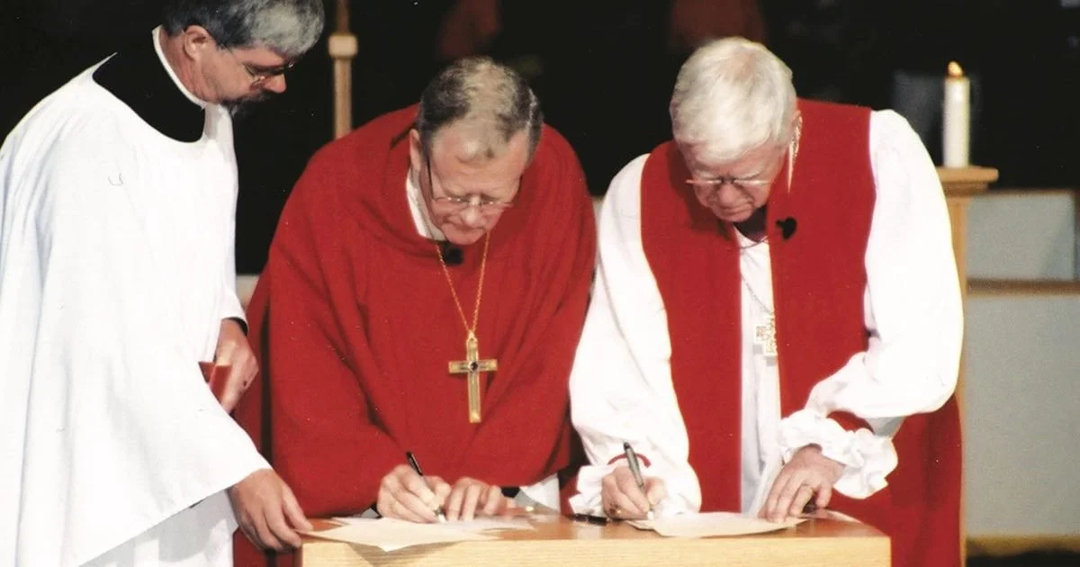 Telmor Sartison, then-national bishop of the Evangelical Lutheran Church in Canada, and Archbishop Michael Peers, then-primate of the Anglican Church of Canada, sign the Waterloo Declaration