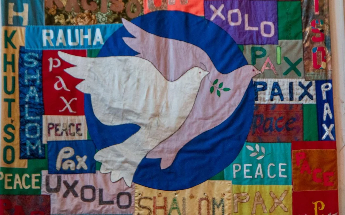 A quilt titled 'Peace and Healing in a Time of Conflict', unveiled by the WCC Commission of the Churches on Health and Healing. The artwork highlights the word 