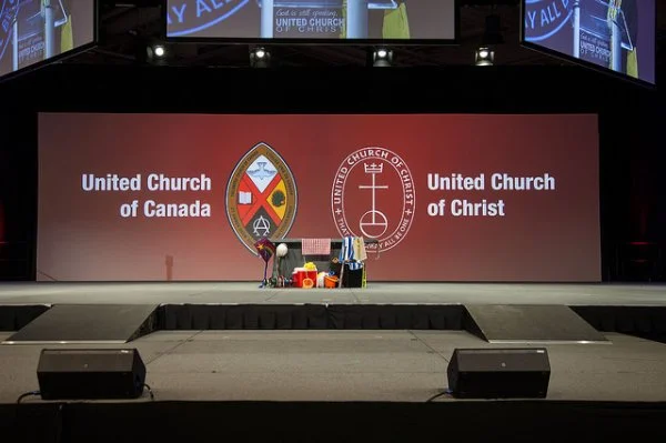 The communion table at the United Church of Christ General Synod in Cleveland with the two churches' crests