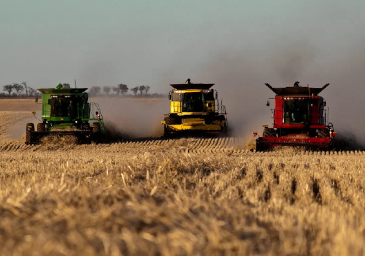 Gathering God's Harvest. Three combines are pictured gathering grain at harvest time
