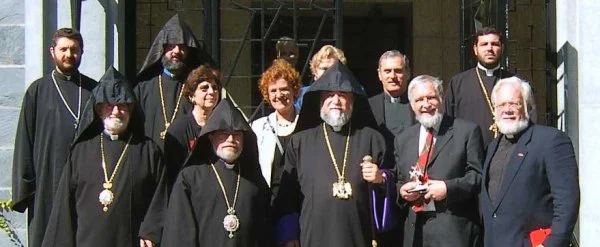 Aram I at the Canadian Centre for Ecumenism. Back row, from left to right: Revd Karnig Koyounian, Very Revd Fr Krikor Chiftjian, Mrs Margaret Brown (hidden behind Aram I’s hood) and Revd Fr Housig Mardirosian. Middle Row: Archbishop Souren Kataroyan, Mrs Renée Legris, Mrs Adèle Brodeur, Deacon Elie Touma. Front Row: The Prelate of Canada, Archbishop Khajag Hagopian, His Holiness Aram I, Dr Stuart E. Brown, Canon David Oliver