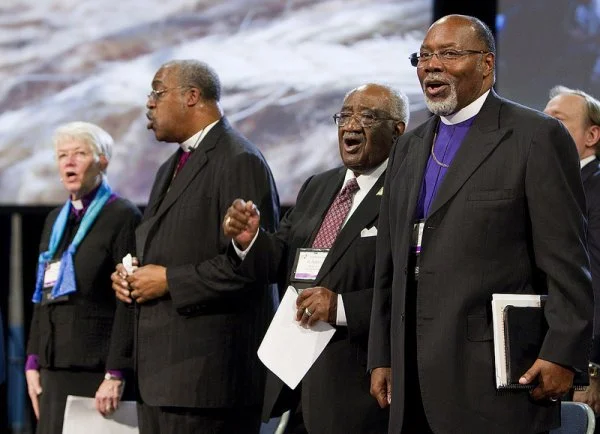 Pan-Methodist church leaders join together at the 2012 United Methodist General Conference in Tampa, Fla. From left are: Bishop Sharon Zimmerman Rader (United Methodist Church), Bishop Thomas Hoyt Jr. (Christian Methodist Episcopal Church), the Rev. W. Robert Johnson III (African Methodist Episcopal Zion Church), and Bishop John F. White (African Methodist Episcopal Church)