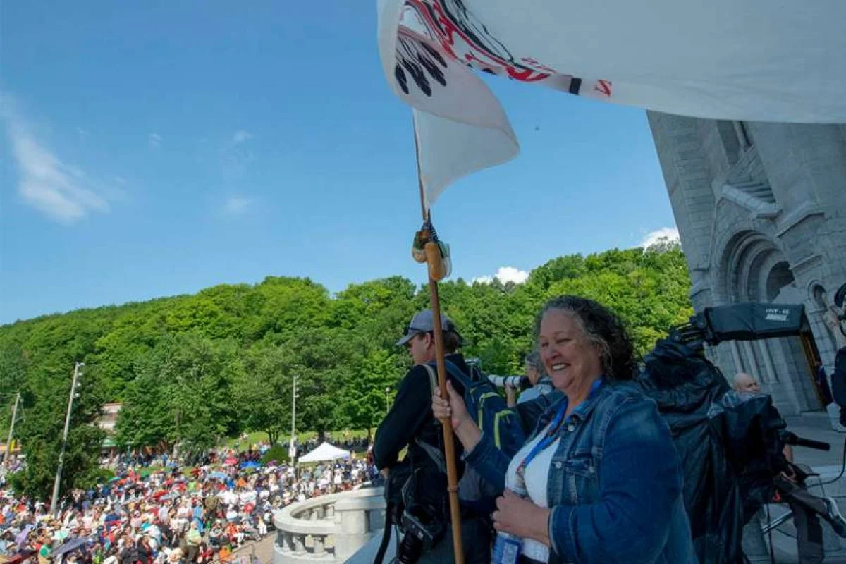 People gather outside the Shrine of Sainte-Anne-de-Beaupré in Quebec, as Pope Francis celebrates Mass
