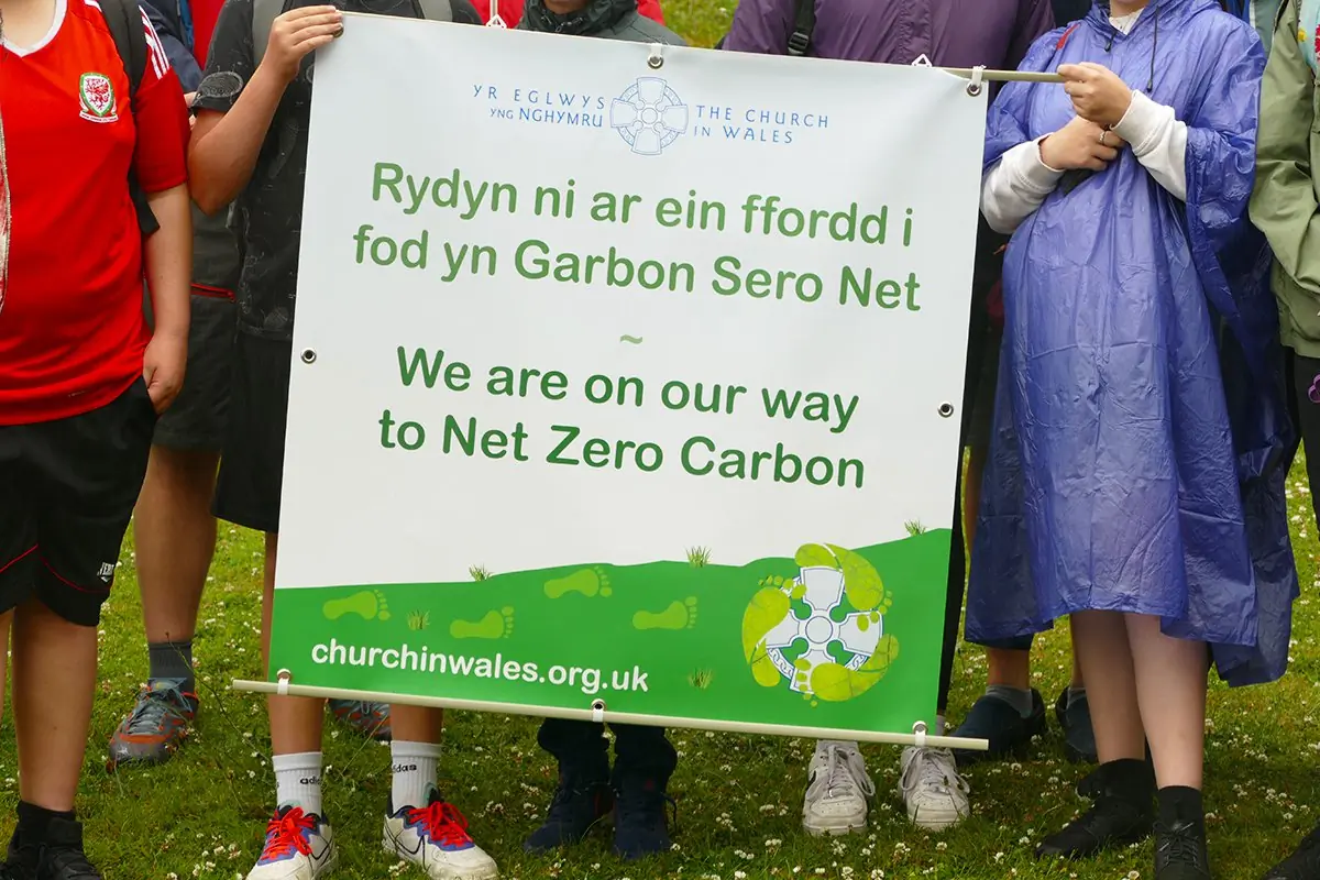 Church members hold banner for the Net Zero Carbon policy of the Anglican Church in Wales