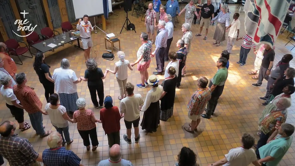 Archdeacon Travis Enright, Lodge Elder of the Standing Stones Sacred Lodge in the Anglican Diocese of Edmonton, leads a Round Dance at the conclusion of the Pêhonân gathering in June, 2023