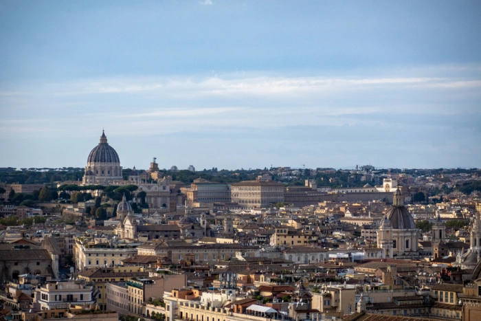 The skyline of Rome from the south of Vatican City with the dome of St. Peter's Basilica on the left and the Apostolic Palace in the centre