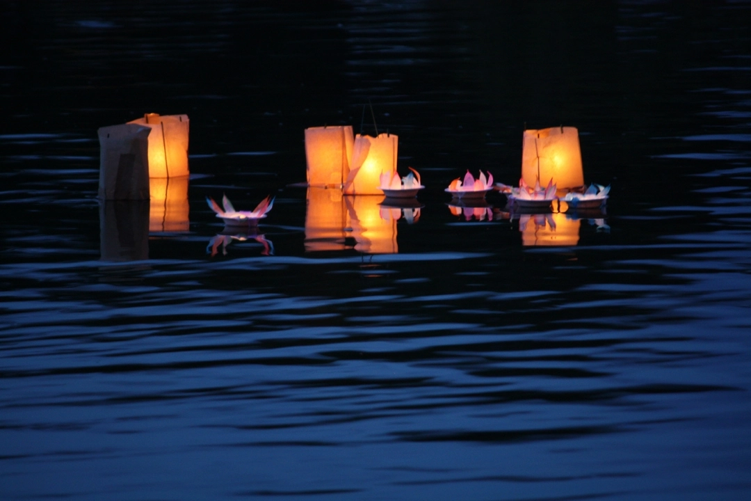 Candles for peace floating on the river Thames near Oxford, England