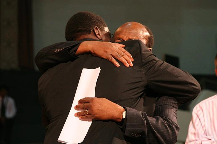 At the Mennonite World Conference Assembly in 2009, MWC President Danisa Ndlovu embraces Ishmael Noko, general secretary of the Lutheran World Federation
