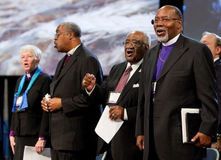 Pan-Methodist church leaders join together at the 2012 United Methodist General Conference in Tampa, Fla. From left are: Bishop Sharon Zimmerman Rader (United Methodist Church), Bishop Thomas Hoyt Jr. (Christian Methodist Episcopal Church), the Rev. W. Robert Johnson III (African Methodist Episcopal Zion Church), and Bishop John F. White (African Methodist Episcopal Church)