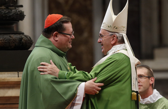 Pope Francis greets Cardinal Gérald Lacroix of Quebec at the conclusion of an Oct. 12 Mass of thanksgiving for the April canonization of two 17th-century Canadian saints