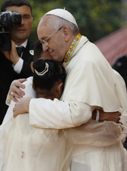 Pope Francis embraces two former street children who spoke during a meeting with young people in Manila, Philippines, Jan. 18. (CNS/Paul Haring)
