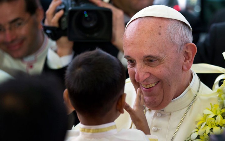 Pope Francis smiled after getting a garland from a child as he arrived for an interfaith meeting in Colombo, Sri Lanka, Tuesday. AP Photo: Saurabh Das