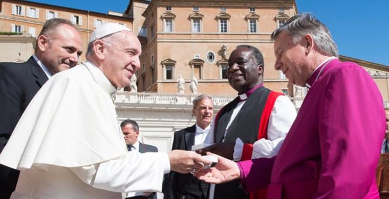 Pope Francis greets New Zealand Archbishop David Moxon, director of Rome's Anglican Centre, and Zambian Bishop William Mchombo of the Central African province at the end of his Wednesday general audience in St Peter's Square