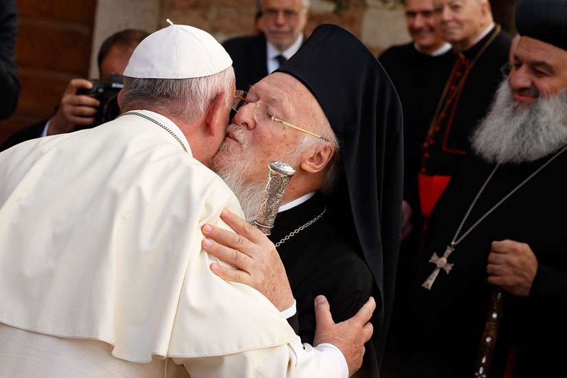 Pope Francis exchanges greetings with Ecumenical Patriarch Bartholomew of Constantinople as he arrives for an interfaith peace gathering at the Basilica of St. Francis in Assisi, Italy. The peace gathering marks the 30th anniversary of the first peace encounter in Assisi in 1986