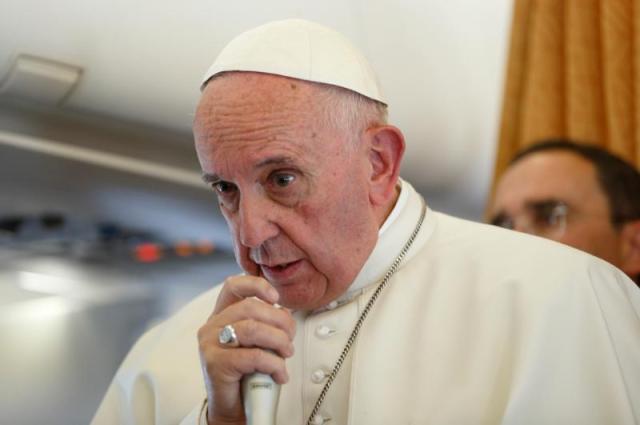 Pope Francis answers questions from journalists aboard his flight from Sweden to Rome Nov. 1. Photo: CNS/Paul Haring