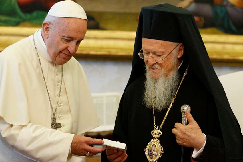 Pope Francis presents a gift to Ecumenical Patriarch Bartholomew of Constantinople during a meeting in the Apostolic Palace at the Vatican May 26. CNS photo/Paul Haring