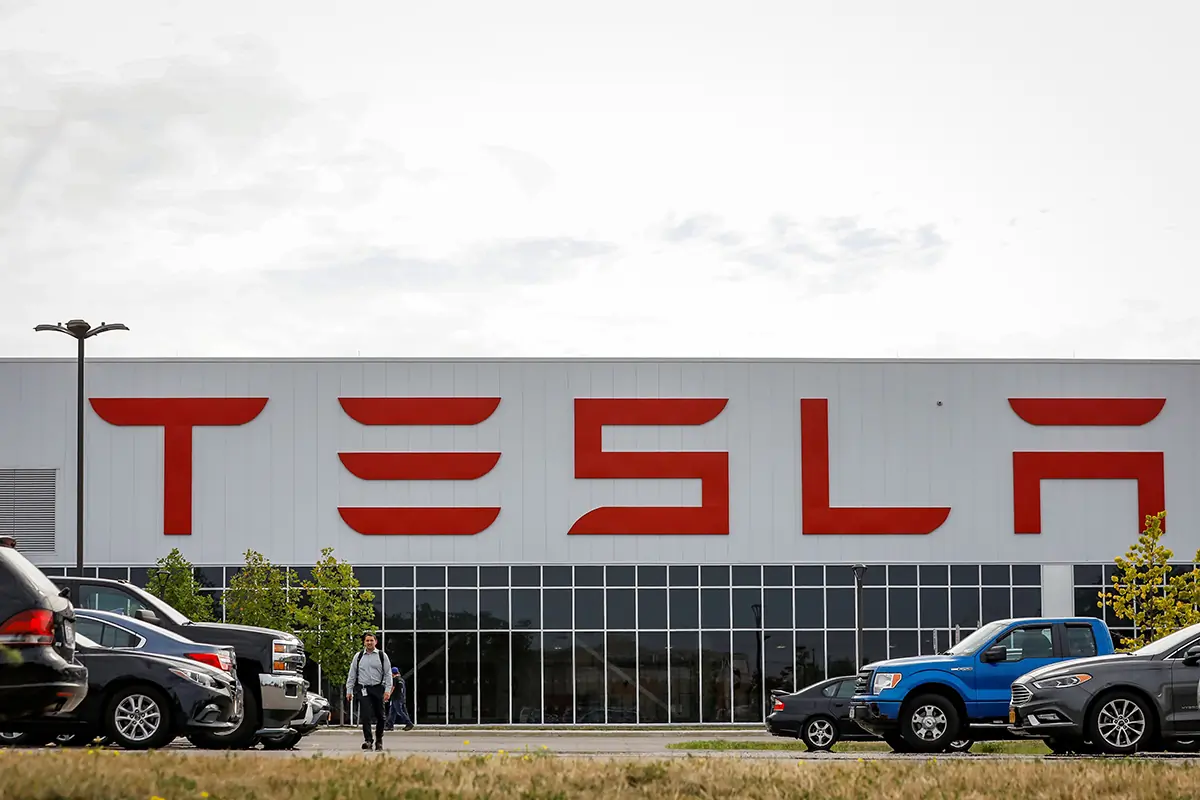 A worker is seen outside Tesla Inc. in Buffalo, N.Y. In heavily Catholic Buffalo, dozens of Tesla employees allege the electric auto manufacturer fired them in retaliation for attempting to form a union — a right at the heart of the church’s social teaching. Tesla faces a complaint before the National Labor Relations Board over the firings, which came within two days of the workers’ Feb. 14, 2023, launch of their unionizing campaign
