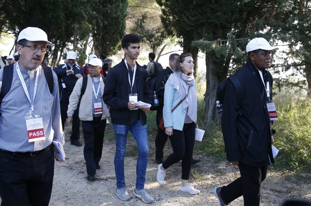 Sebastian Duhau, a synod observer from Australia, and Emilie Callan, a synod observer from Canada, participate in a pilgrimage hike from the Monte Mario nature reserve in Rome to St. Peter's Basilica at the Vatican. Cardinal Christoph Schonborn of Vienna said synodality refers to all the baptized taking responsibility for the church and its mission, each according to his or her talents and role within the church