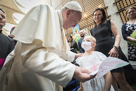 Matildes Colombo, who was recently diagnosed with leukemia, presents a drawing to Pope Francis at the Ecumenical Centre in Geneva