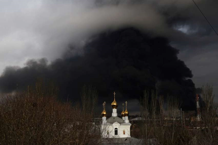 An Orthodox church is seen in front an oil refinery that caught fire following a missile attack near the port city of Odesa, Ukraine