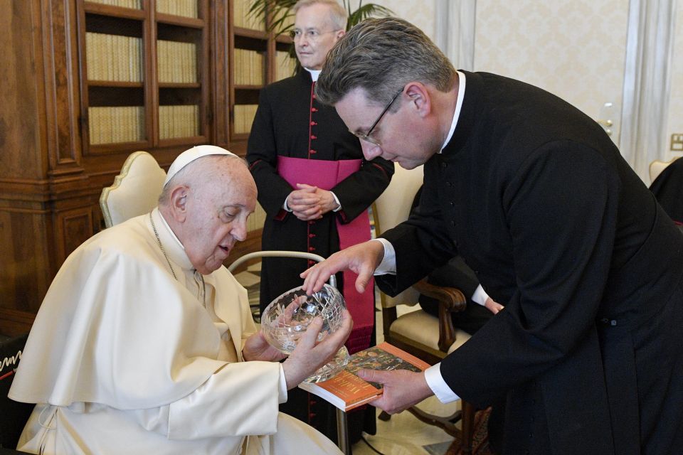 The Rev. Will Adam, deputy secretary-general of the Anglican Communion, presents a gift to Pope Francis during an audience with ARCIC-III