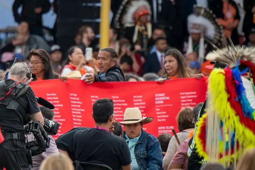 A red memorial banner inscribed with 4120 names of many of the children who never came home from all residential schools across Canada is carried at a meeting with Pope Francis at Maskwacis, Alberta