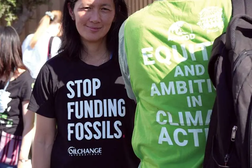 A protester wears a t-shirt with the message 'Stop funding fossils' during a demonstration at the COP27 climate summit in Sharm el-Sheikh, Egypt