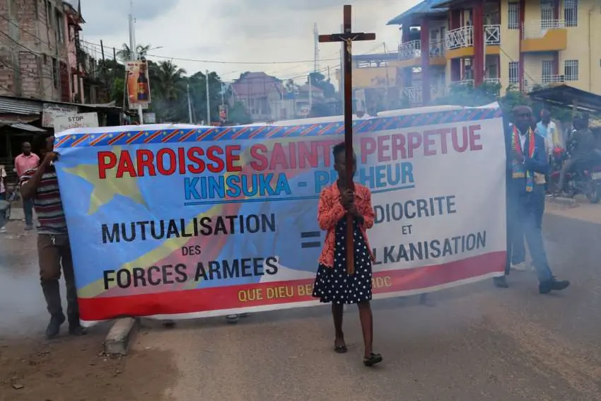 A young woman carries a Cross during a march in Kinshasa, Democratic Republic of Congo, to protest escalating violence in the country
