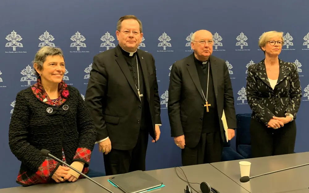 Speakers at a Vatican news conference pose for a photo after talking to journalists about the Dicastery for Laity, the Family and Life's international gathering to promote closer cooperation and a sense of co-responsibility between clergy and laity. From the left: Andrea Poretti, a leader of the Sant'Egidio Community in Argentina; Cardinal Gérald Lacroix of Quebec; Cardinal Kevin Farrell, dicastery prefect; and Linda Ghisoni, dicastery undersecretary