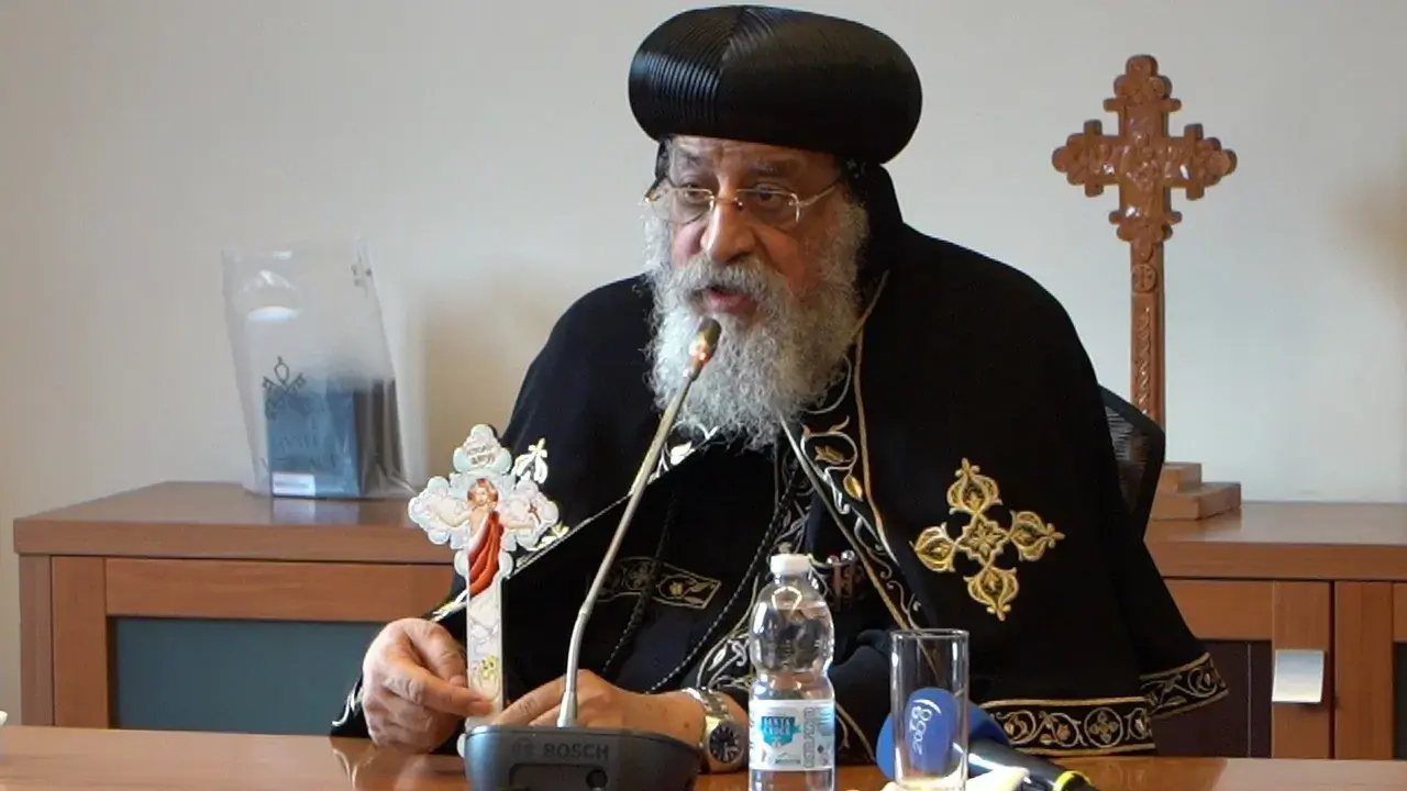 Pope Tawadros II holds up a cross to help explain the steps of ecumenical dialogue. The Coptic pope spoke to a news conference at the Vatican's Dicastery for Promoting Christian Unity