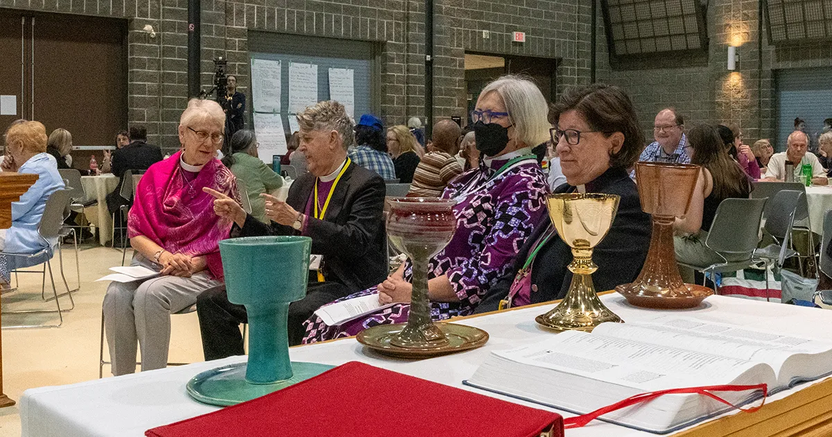 Leaders from the four main Anglican and Lutheran churches in North America prepare to exchange communion cups at Assembly in Calgary. Left to right are: Archbishop Linda Nicholls, primate of the Anglican Church of Canada; William Franklin, bishop of Long Island in The Episcopal Church; Susan Johnson, national bishop of the Evangelical Lutheran Church in Canada; and Elizabeth Eaton, presiding bishop of the Evangelical Lutheran Church in America