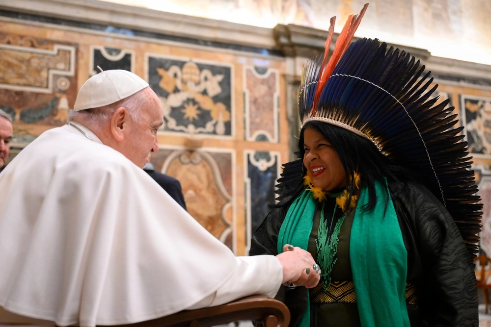 Pope Francis shakes hands with an Indigenous woman during an audience at the Vatican with people taking part in a workshop jointly sponsored by the Pontifical Academies of Sciences and of Social Sciences on the knowledge of Indigenous peoples and research carried out in the sciences