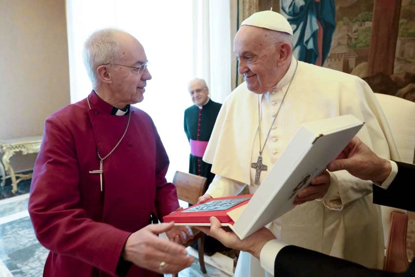 Pope Francis gives a gift to Anglican Archbishop Justin Welby of Canterbury during a meeting with Anglican primates in the Apostolic Palace at the Vatican