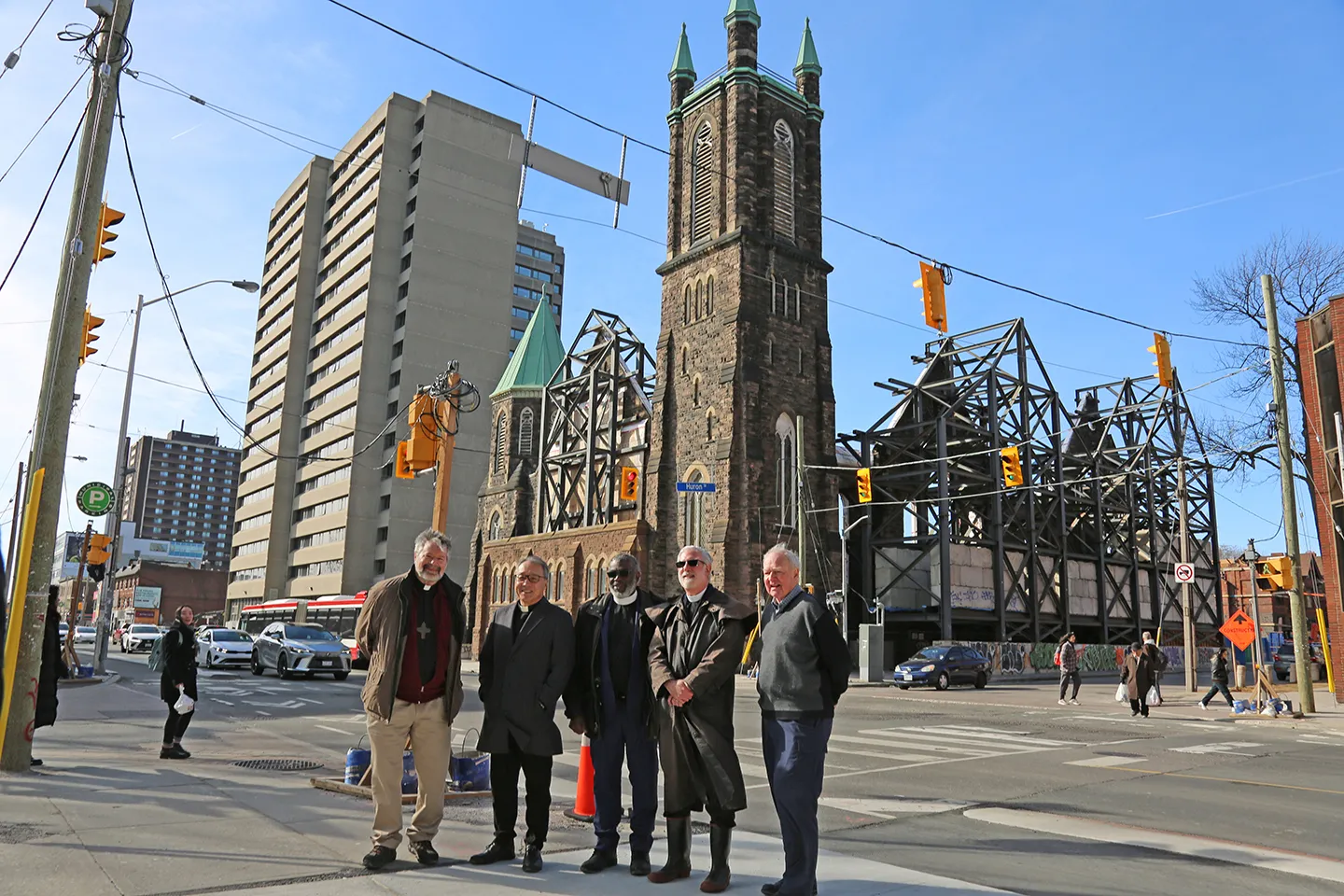 Representatives from the three partner churches stand in front of the construction site at Bloor Street United Church in Toronto. The national offices for the Anglican, Presbyterian, and United churches will be moving to the newly-built offfice space in 2026. From left to right: Rev. Douglas Ducharme, minister of Bloor Street United, Rev. Victor Kim, principal clerk of the PCC, Rev. Michael Blair, general secretary of the UCC, Rev. Alan Perry, general secretary of the ACC, and Bob Hilliard, trustee of Bloor Street United