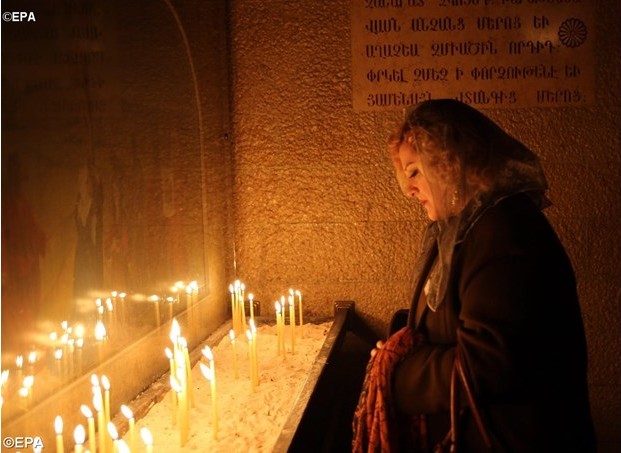 A woman prays at an Armenian Orthodox church in Damascus, Syria